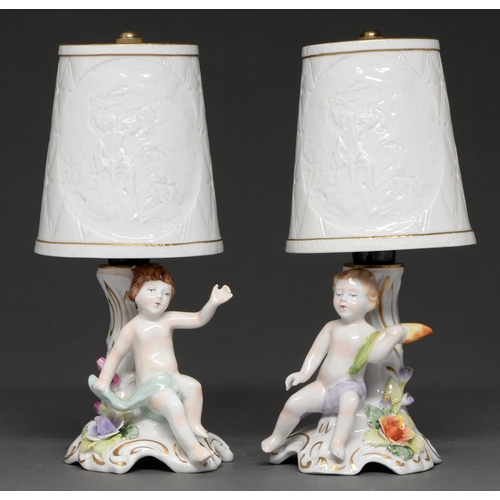 A pair of German porcelain figural lamps