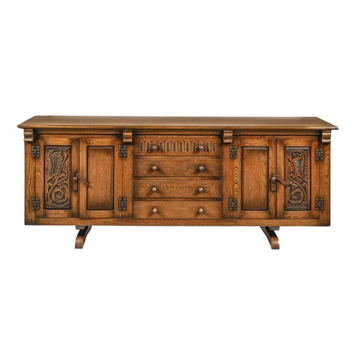 An oak sideboard, 20th c, with carved