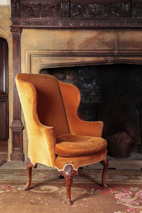 A QUEEN ANNE WALNUT WING ARMCHAIR with