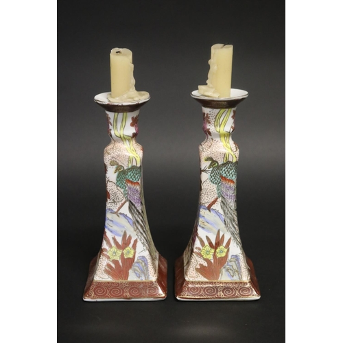 Pair of floral decorated porcelain candlesticks,