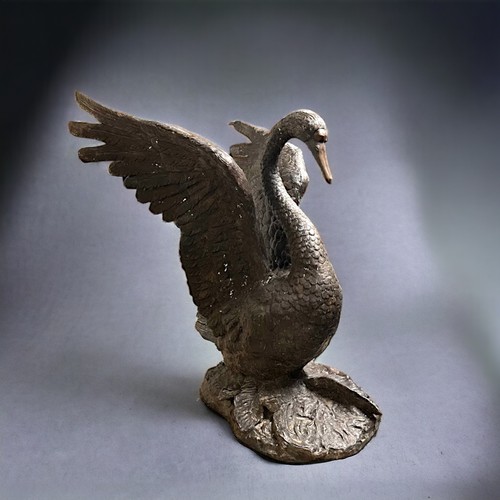 A LARGE CAST BRONZE SCULPTURE OF A SWAN.