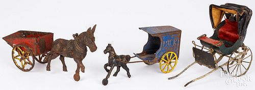 TWO CAST IRON AND TIN HORSE DRAWN CARTSTwo