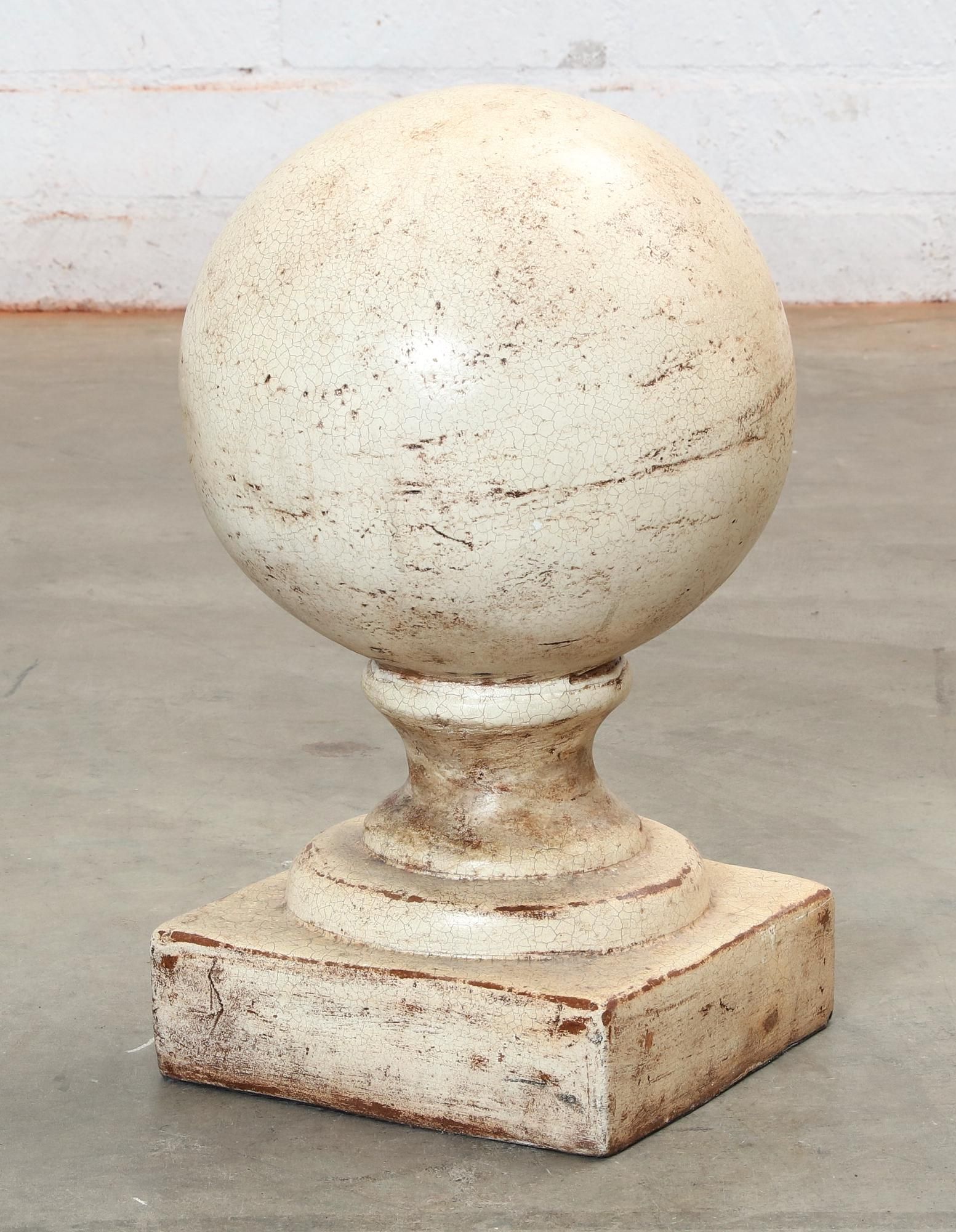 A WHITE PAINTED TERRACOTTA SPHERE 2fb28ee