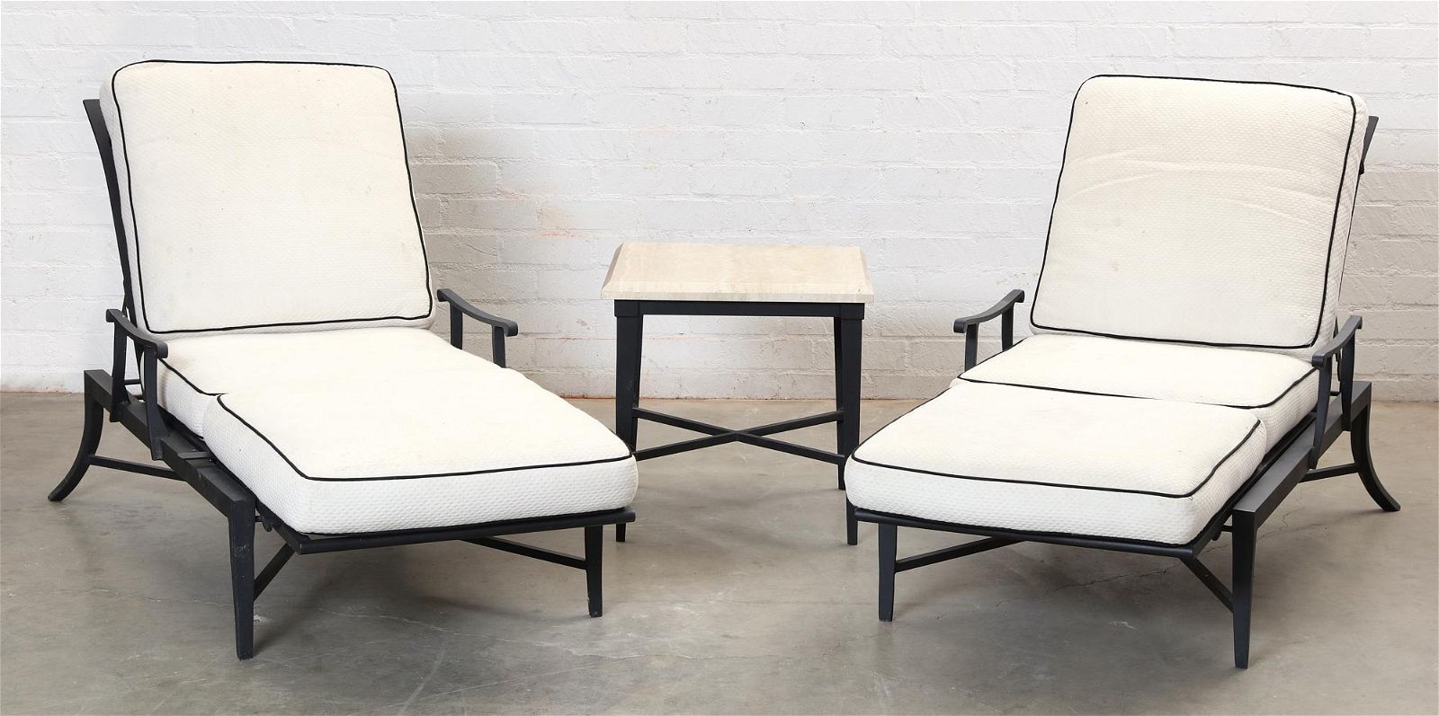 A PAIR OF EBONIZED CHAISES LOUNGE &