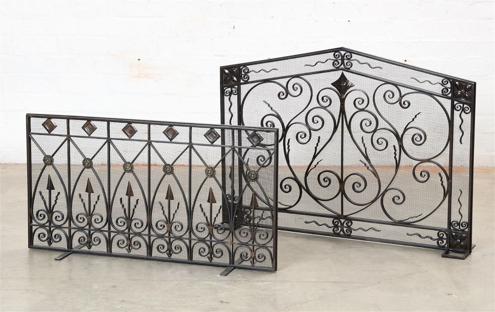 TWO WROUGHT IRON FIRE SCREENSTwo wrought