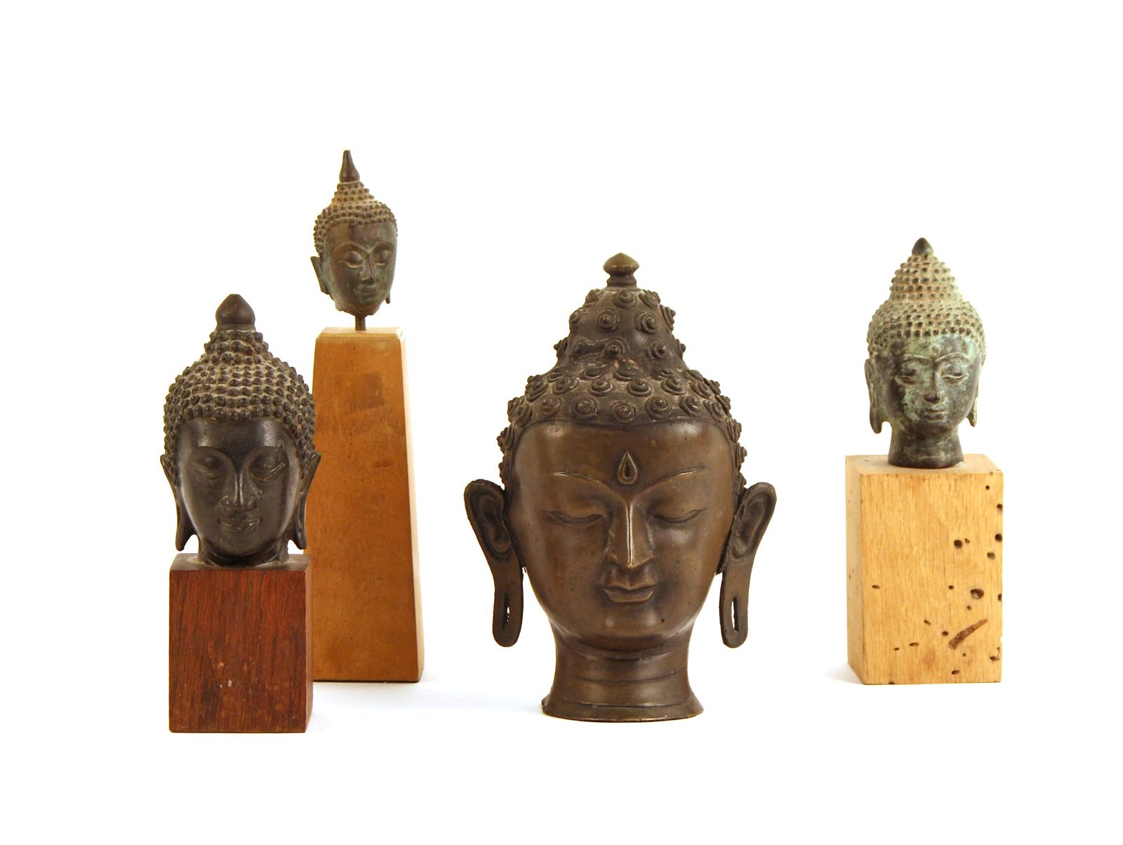 FOUR BRONZE BUDDHA HEADSFour bronze 2fb2ee8