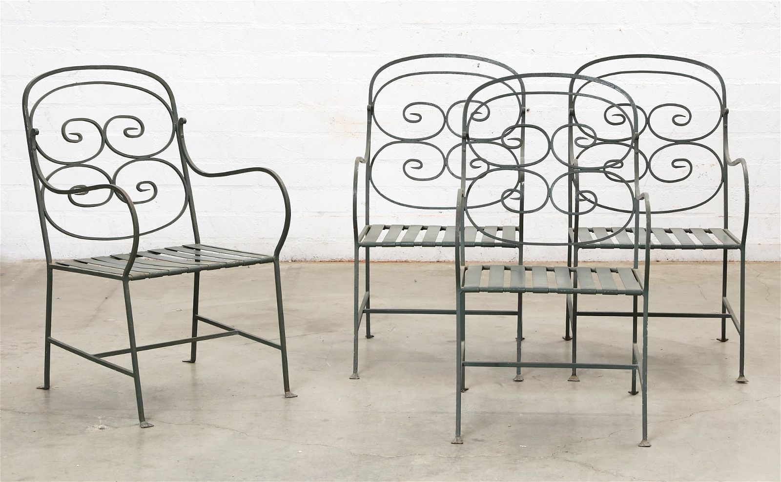 A SET OF FOUR CAST IRON GARDEN ARMCHAIRSA