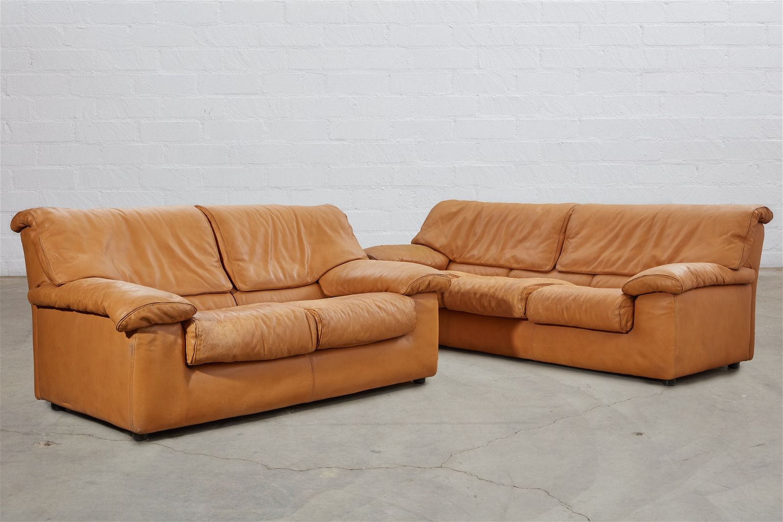 A ROCHE BOBOIS CAMEL LEATHER SOFA AND