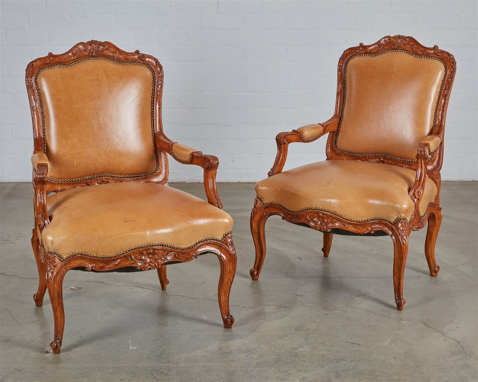 A PAIR OF LOUIS XV STYLE WALNUT FAUTEUILSA