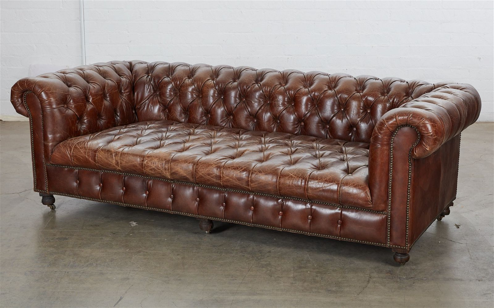 A BROWN LEATHER TUFTED CHESTERFIELD 2fb4247