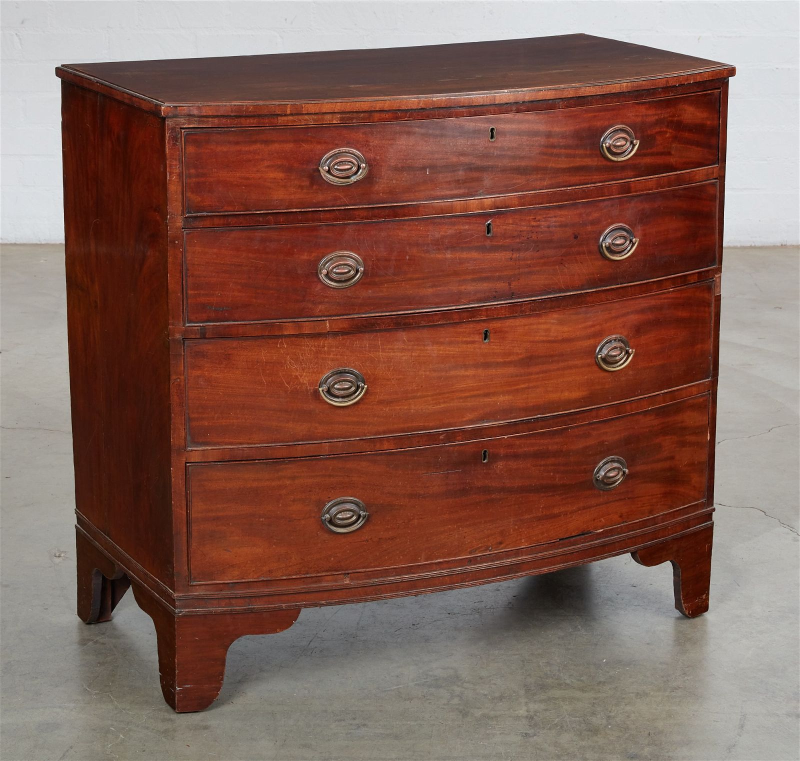 A GEORGE III MAHOGANY BOW FRONT CHEST