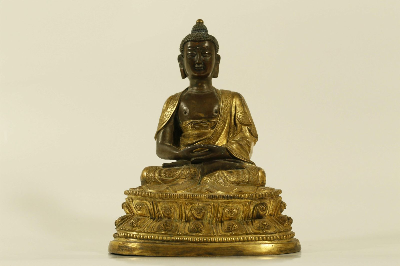 A GILT-BRONZE FIGURE OF MEDICINE