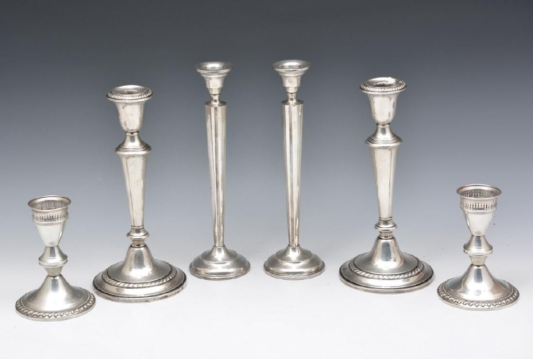 THREE PAIRS OF STERLING SILVER CANDLESTICKSThree