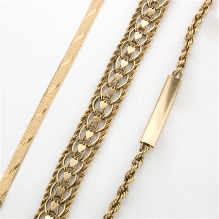 Three Gold and Metal Bracelets
	