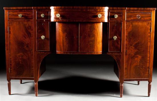 Late Federal carved mahogany shaped-front