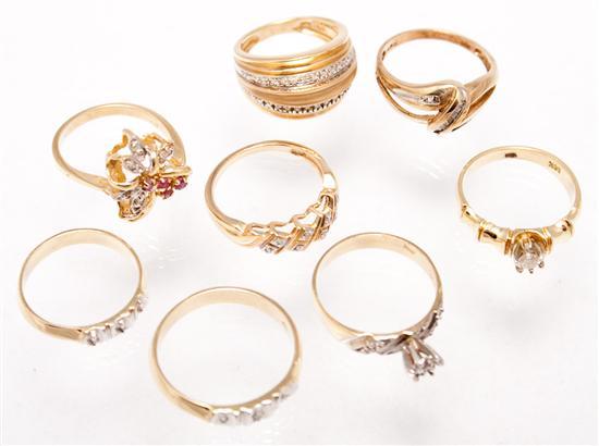 Seven 14K yellow gold and diamond rings,