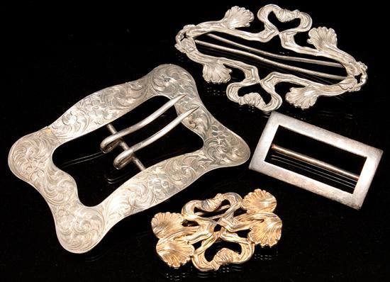 Four silver belt buckles, including