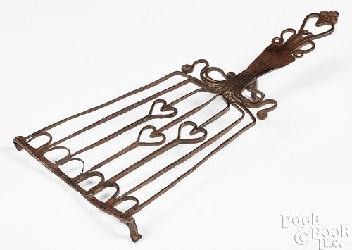 AN ELABORATE WROUGHT IRON TRIVET,