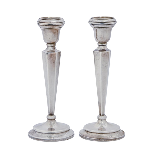 A pair of George V silver candlesticks, with
