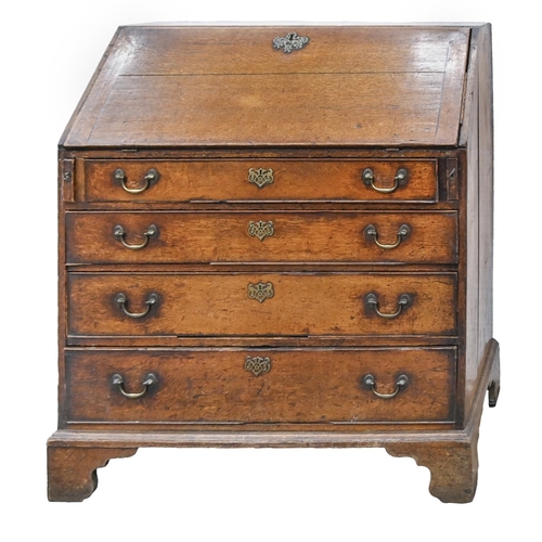 A George III oak bureau, with fitted