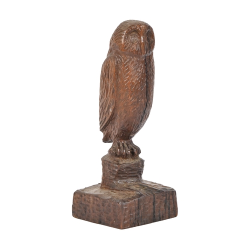 A carved wood sculpture of an owl on