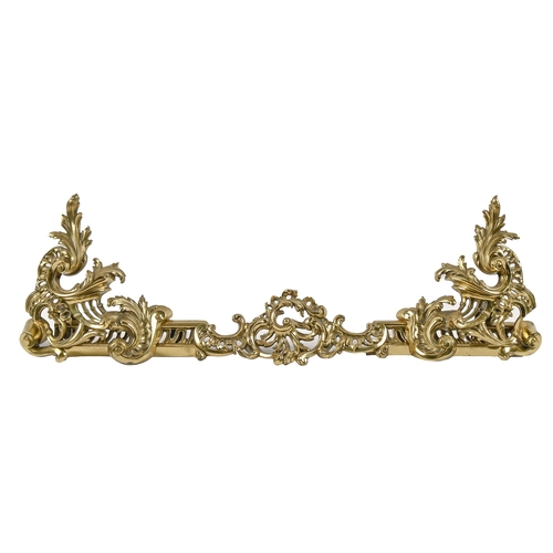 An ornate pierced brass fender,