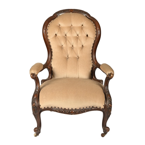 A Victorian walnut open armchair,