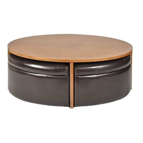 An oval light wood coffee table and