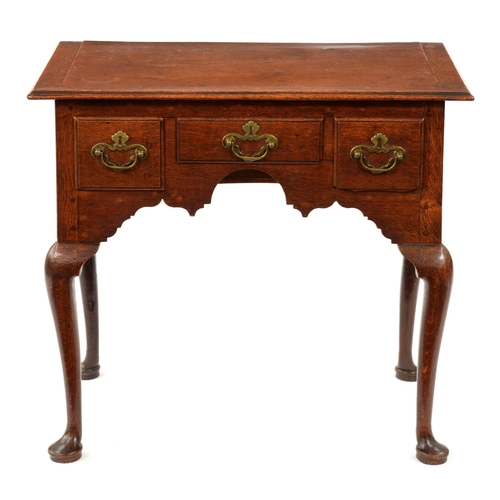 A George III oak lowboy, the moulded