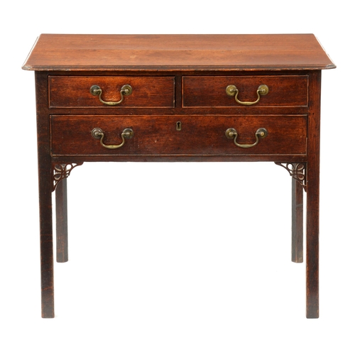 A George III oak lowboy, with three