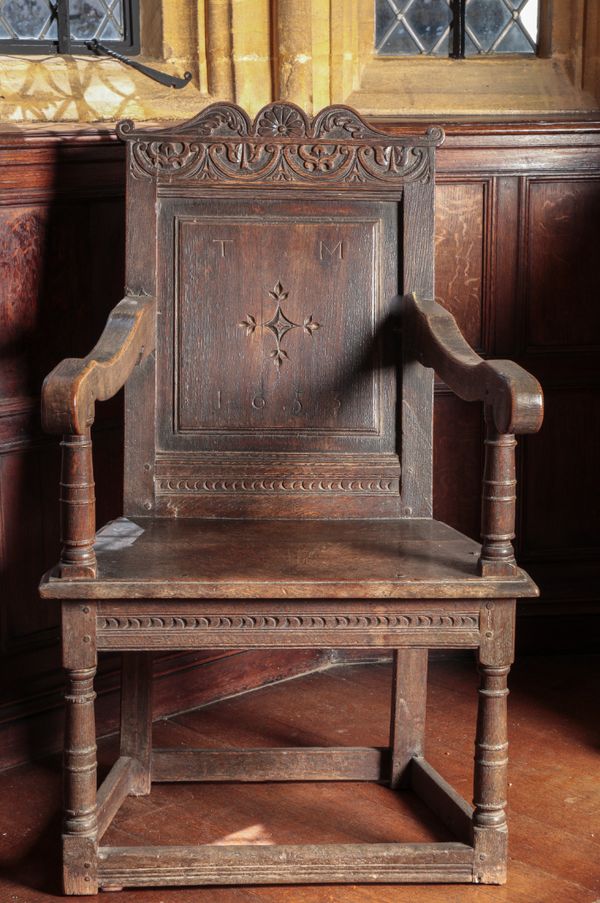 A CROMWELLIAN OAK "WAINSCOT" ARMCHAIR