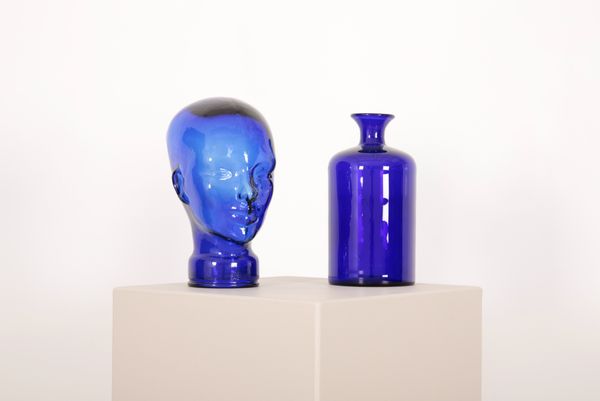 A MOULDED BLUE GLASS MANNEQUIN