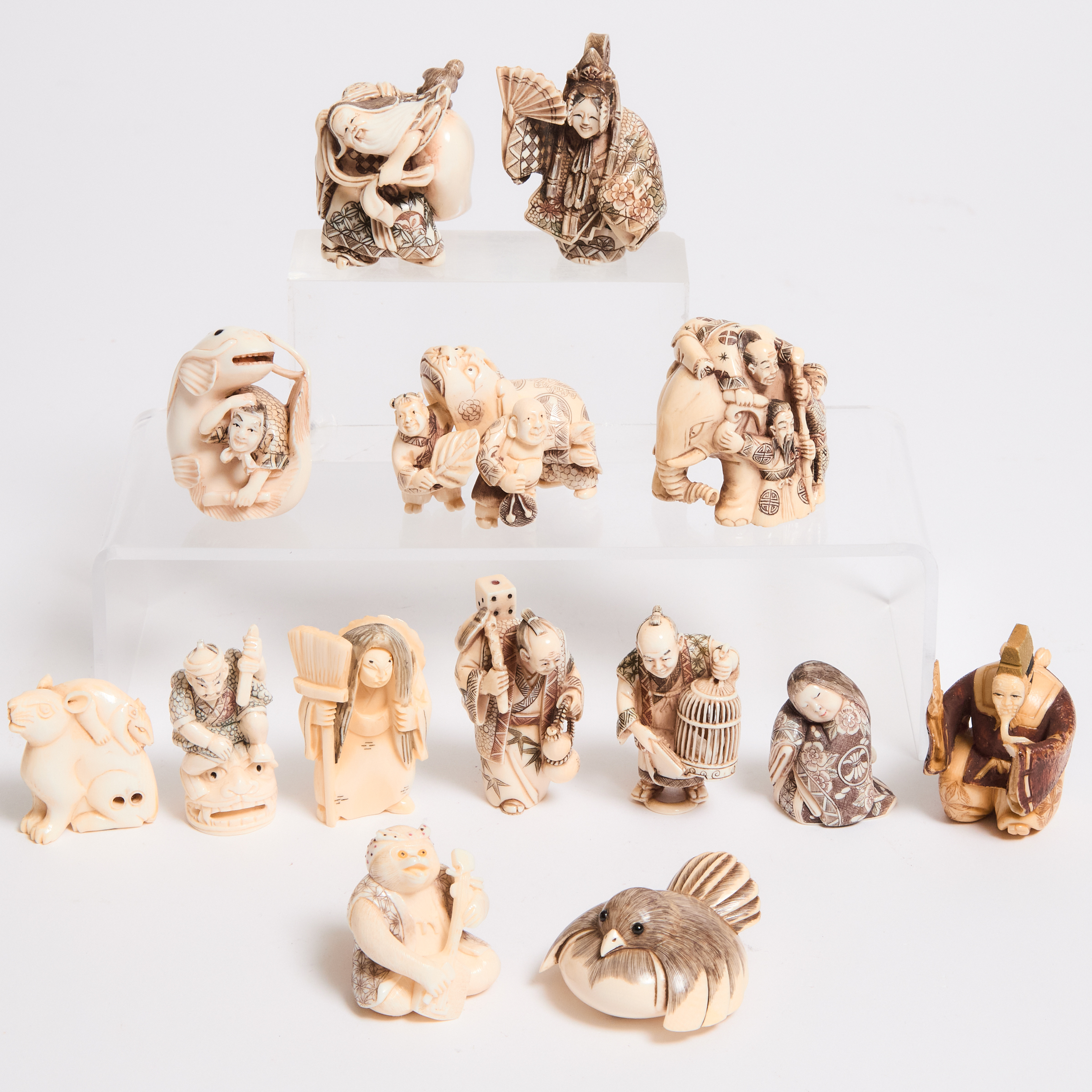 A Group of Fourteen Ivory Netsuke,