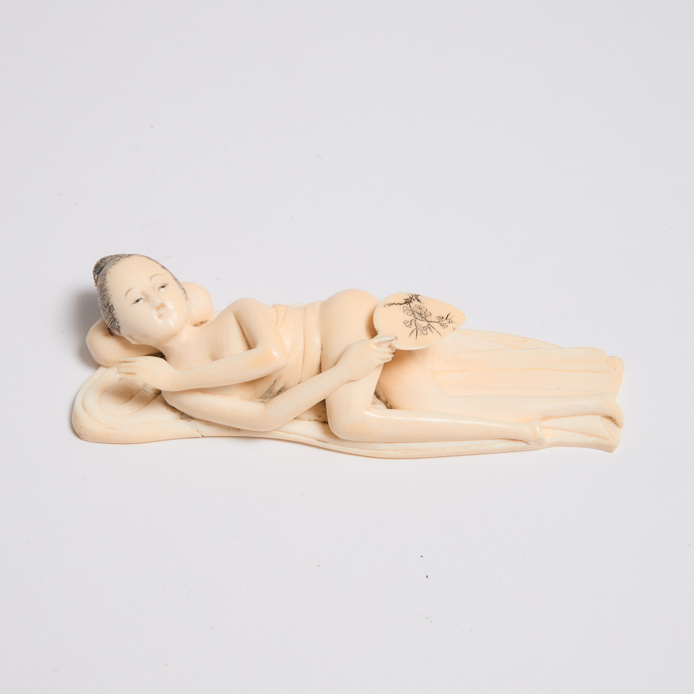 An Ivory Figure of a Reclining