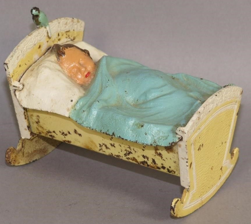 IRON & TIN POLYCHROME PAINTED BABY IN