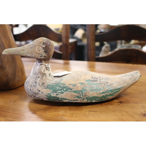 Wooden pond duck with old paint,