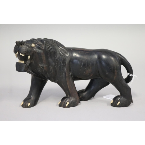 Carved hardwood lion figure, missing