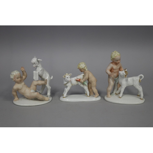 Three porcelain figures of putti with