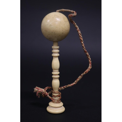 Antique ivory ball on turned ivory stand,