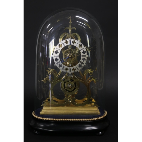 Brass skeleton clock under glass