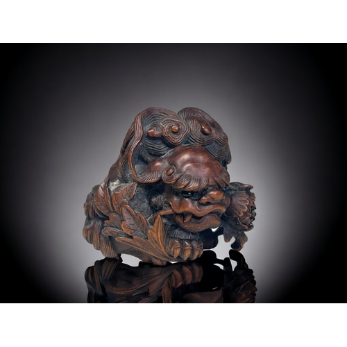 A finely carved wood Shishi Lion