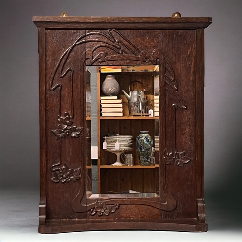 Art Nouveau carved oak wall mirror.