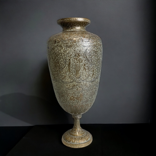AN INDIAN CHISELLED BRASS VASE.