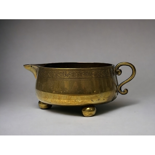 A Victorian brass milk jug.Squat body,