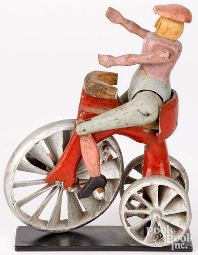 FIGURE RIDING A HIGH WHEEL BICYCLECarved