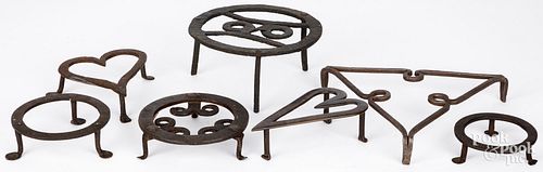 SEVEN WROUGHT IRON TRIVETS, 19TH