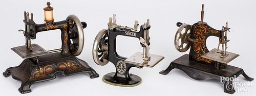 THREE CHILDREN'S TOY SEWING MACHINESThree