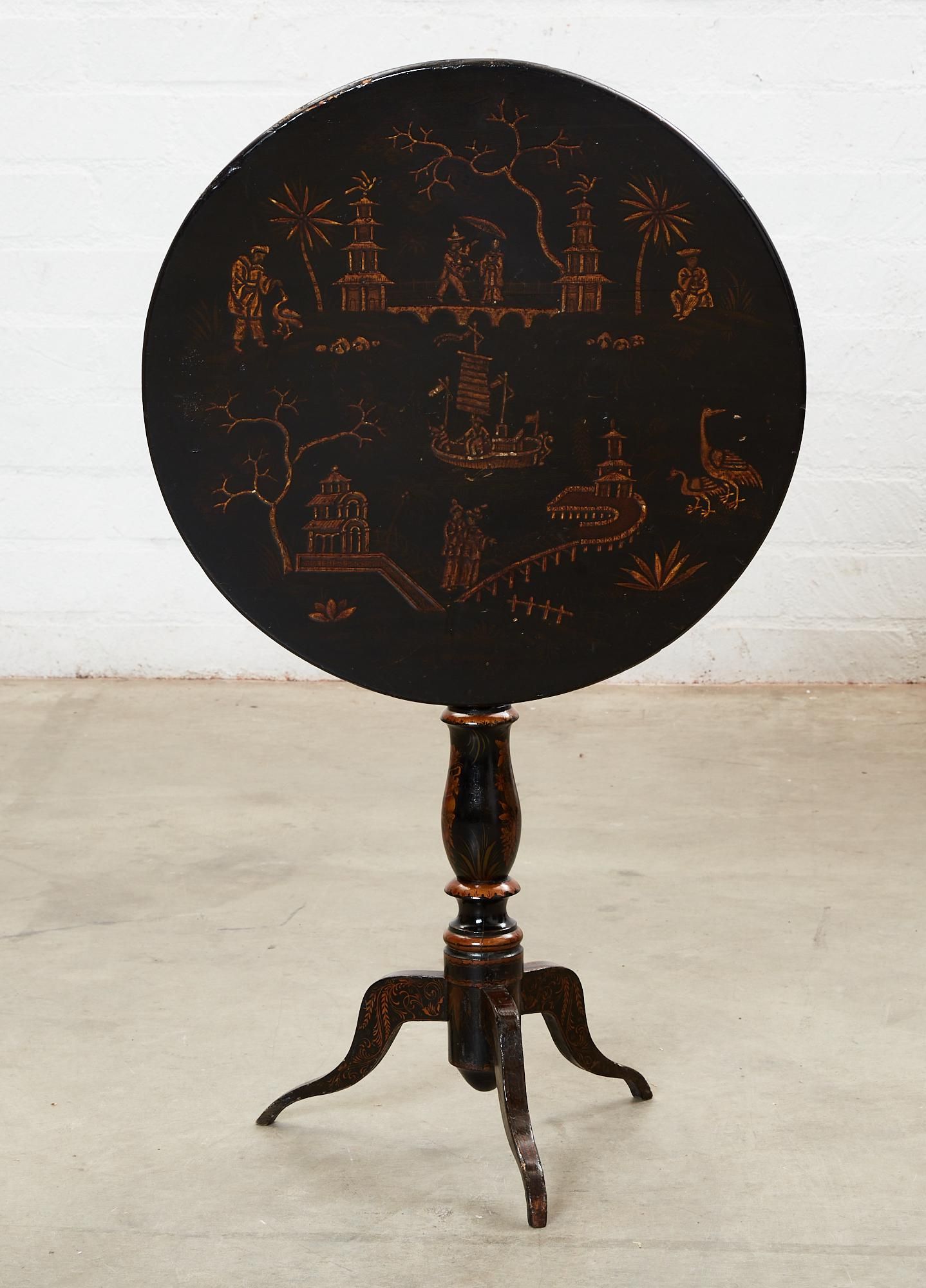 A VICTORIAN JAPANNED TILT TOP TABLEA