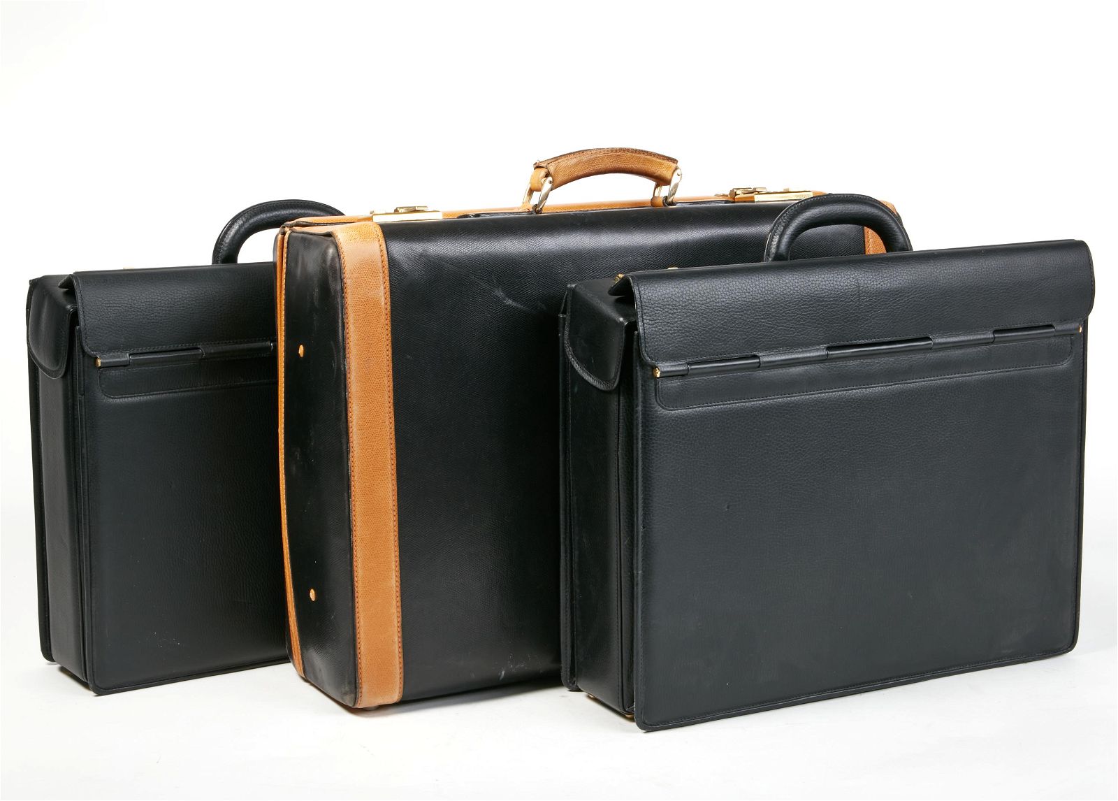 THREE LEATHER SUITCASESThree leather