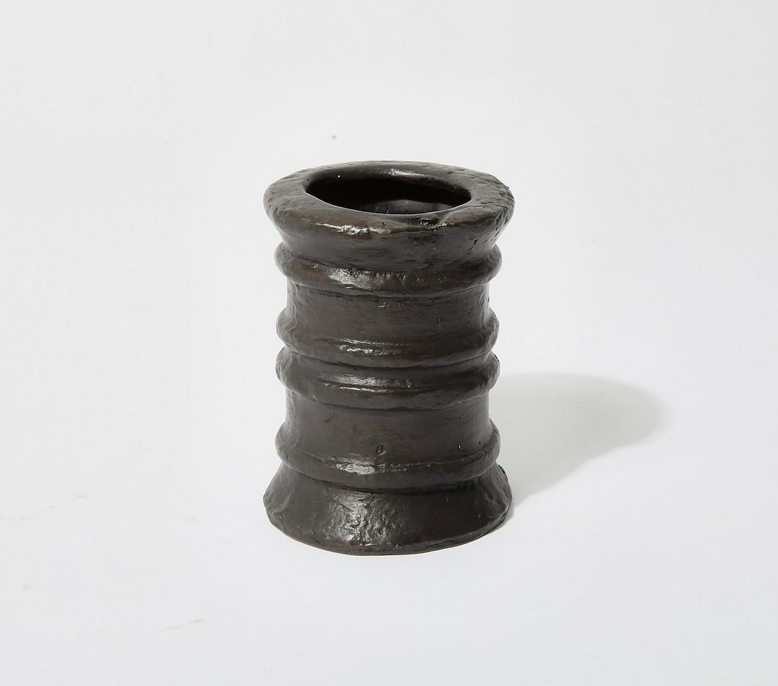 A PATINATED BRONZE CYLINDRICAL